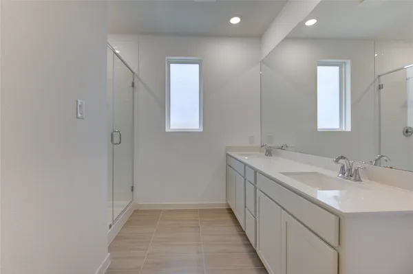 a bathroom with a double vanity sink and mirror