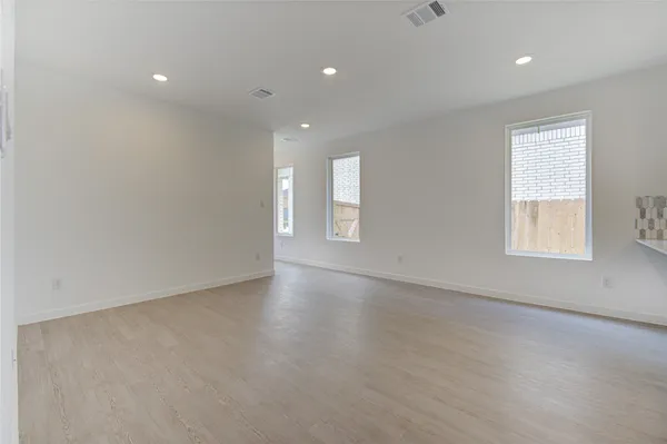 an empty room with windows and closet