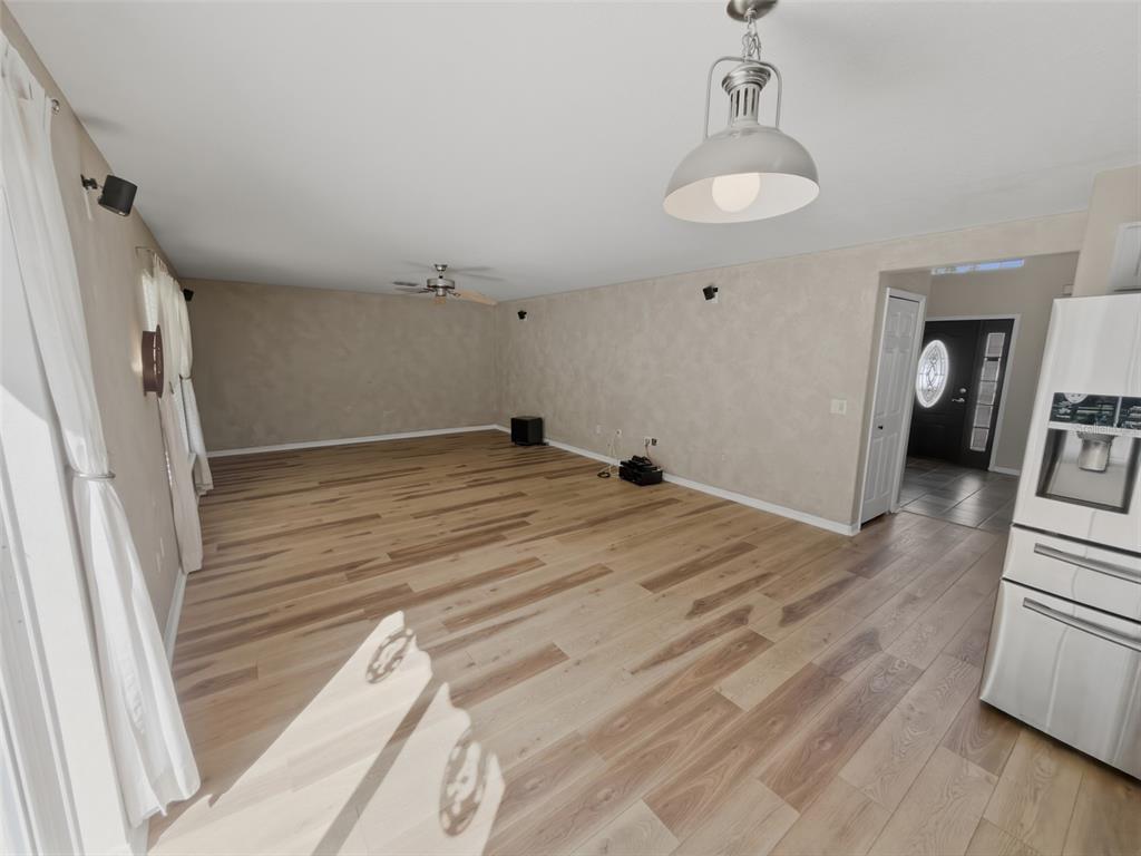 13302 Mitten Lane Spring Hill, FL 34609 - Photo 21 of 59 a view of empty room with wooden floor