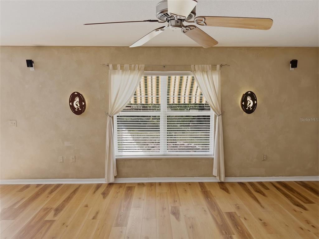 13302 Mitten Lane Spring Hill, FL 34609 - Photo 23 of 59 a view of an empty room with a window and wooden floor