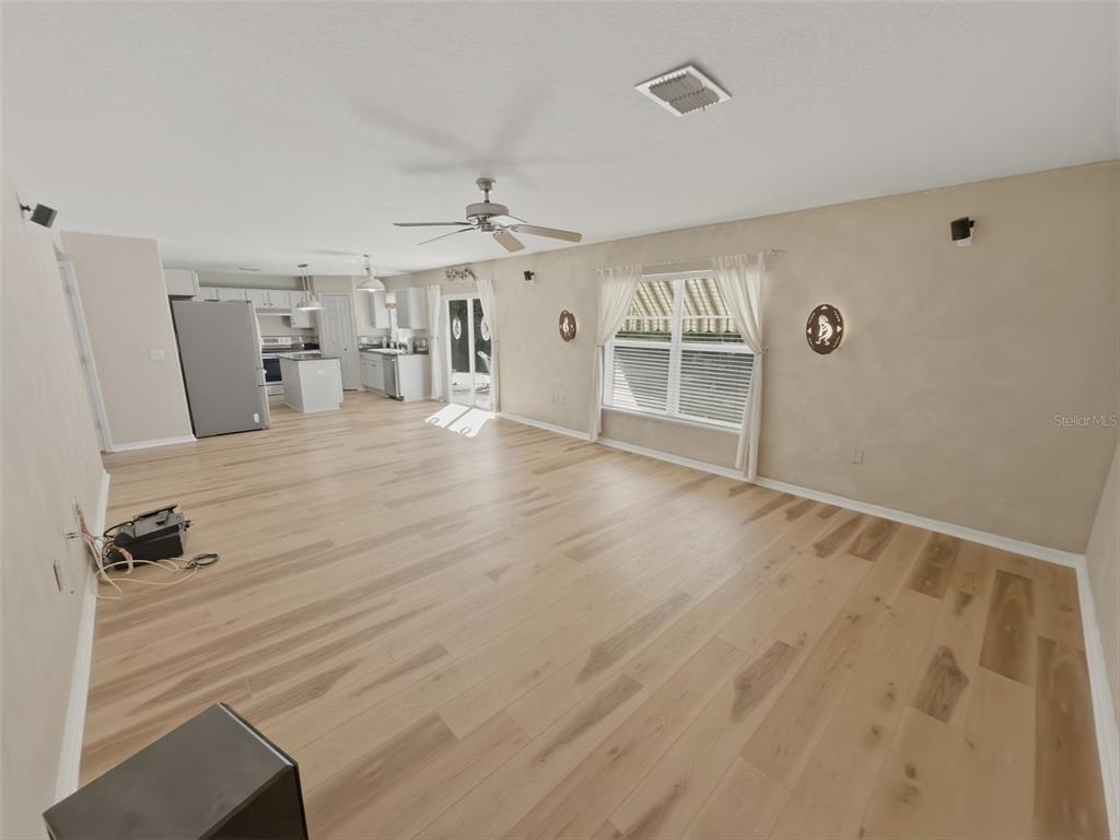 13302 Mitten Lane Spring Hill, FL 34609 - Photo 24 of 59 wooden floor in an empty room with a window