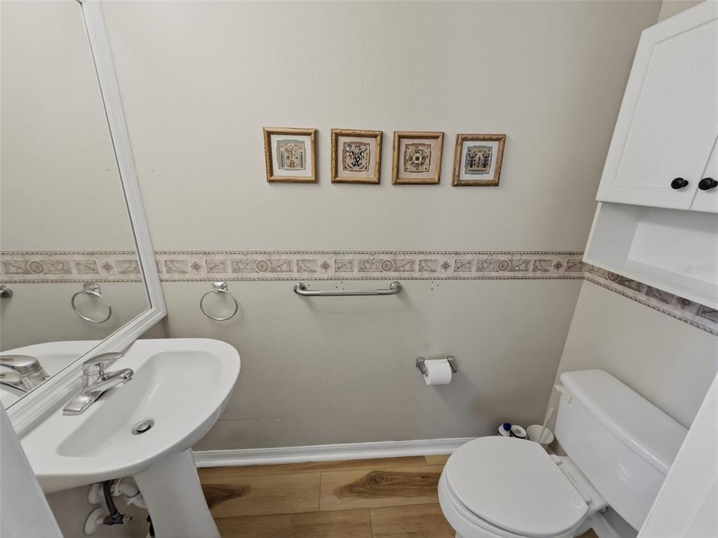 13302 Mitten Lane Spring Hill, FL 34609 - Photo 25 of 59 a bathroom with a sink mirror and toilet