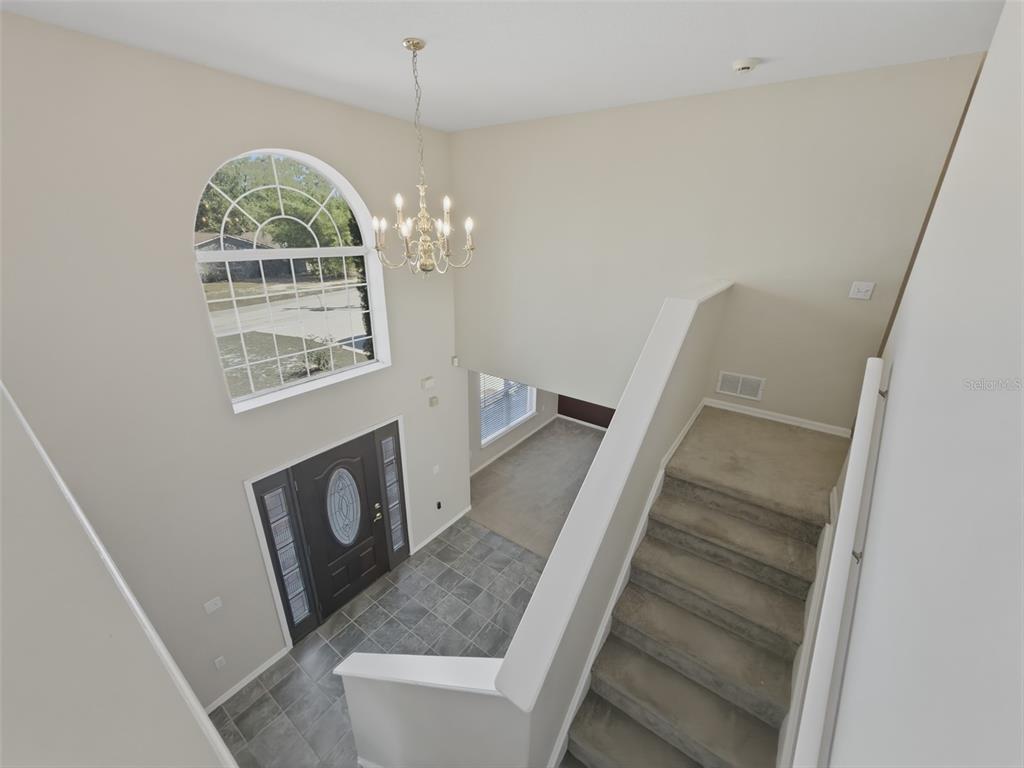 13302 Mitten Lane Spring Hill, FL 34609 - Photo 26 of 59 a view of entryway and hall with wooden floor