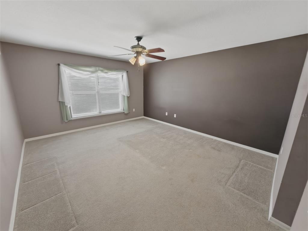 13302 Mitten Lane Spring Hill, FL 34609 - Photo 29 of 59 an empty room with windows and fan