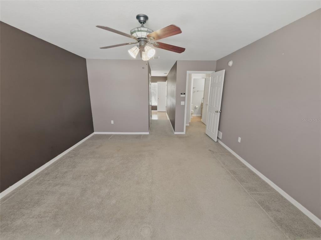 13302 Mitten Lane Spring Hill, FL 34609 - Photo 30 of 59 an empty room with a ceiling fan and a window