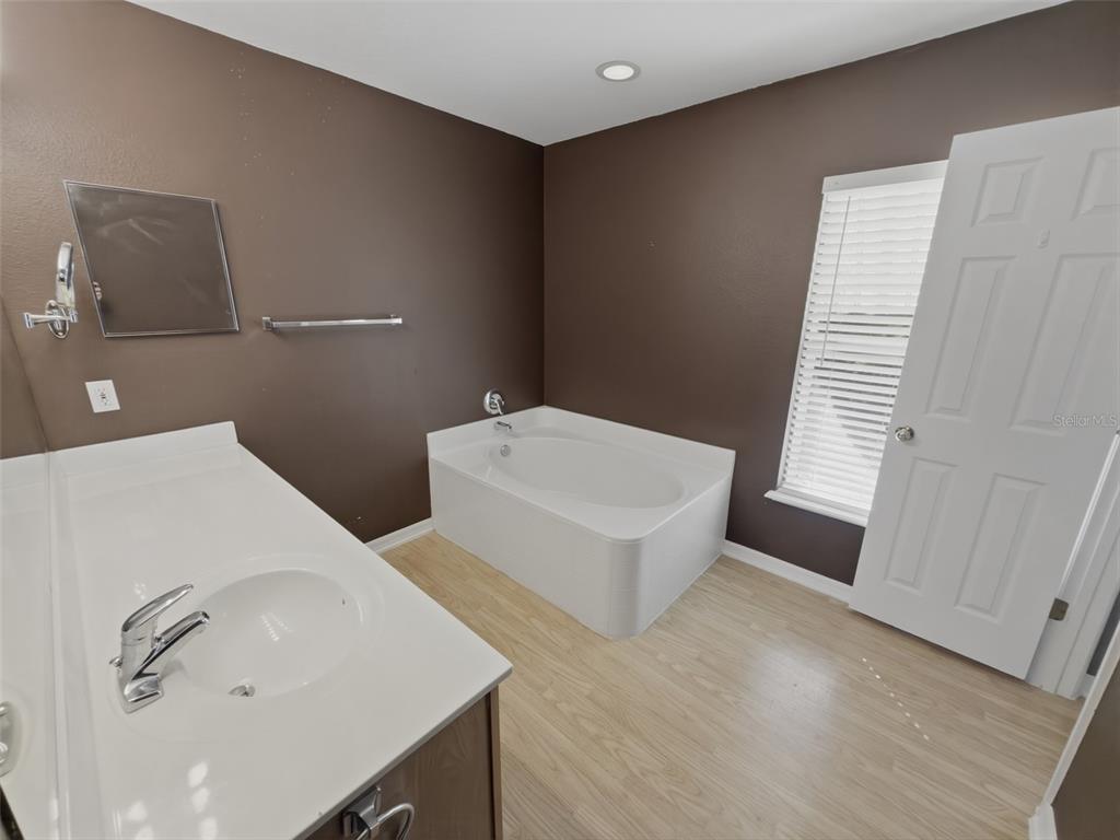 13302 Mitten Lane Spring Hill, FL 34609 - Photo 32 of 59 a bathroom with a sink and mirror