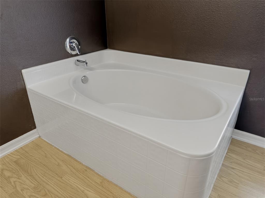 13302 Mitten Lane Spring Hill, FL 34609 - Photo 33 of 59 a white bath tub sitting in a bathroom