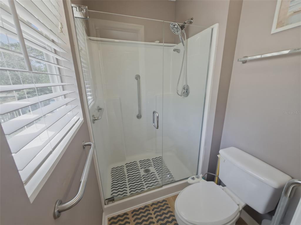 13302 Mitten Lane Spring Hill, FL 34609 - Photo 35 of 59 a bathroom with a toilet and shower