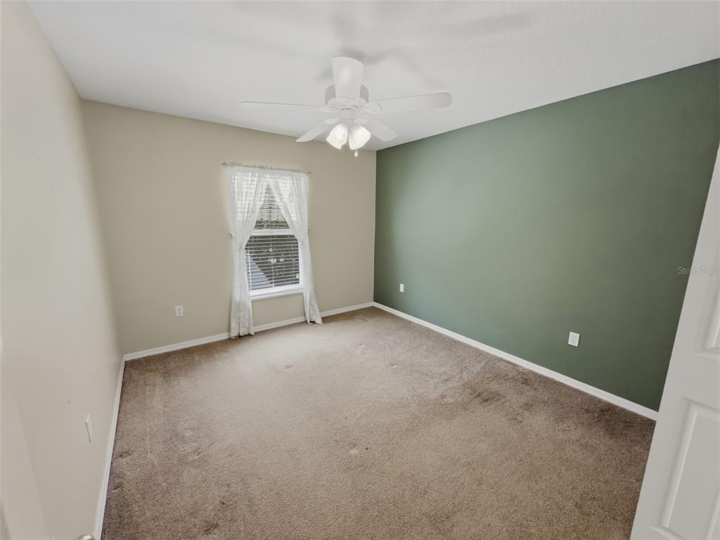13302 Mitten Lane Spring Hill, FL 34609 - Photo 36 of 59 an empty room with a windows and chandelier