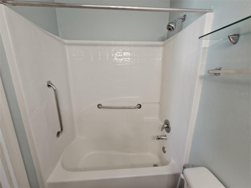 13302 Mitten Lane Spring Hill, FL 34609 - Photo 39 of 59 a bathroom with a shower and a toilet