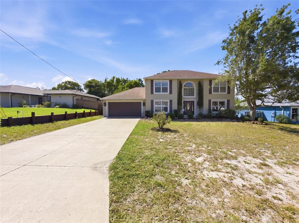 13302 Mitten Lane Spring Hill, FL 34609 - Photo 4 of 59 a front view of a house with a yard