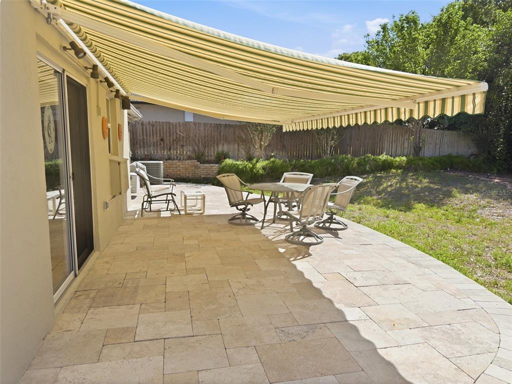 13302 Mitten Lane Spring Hill, FL 34609 - Photo 46 of 59 a view of a patio with table and chairs and potted plants