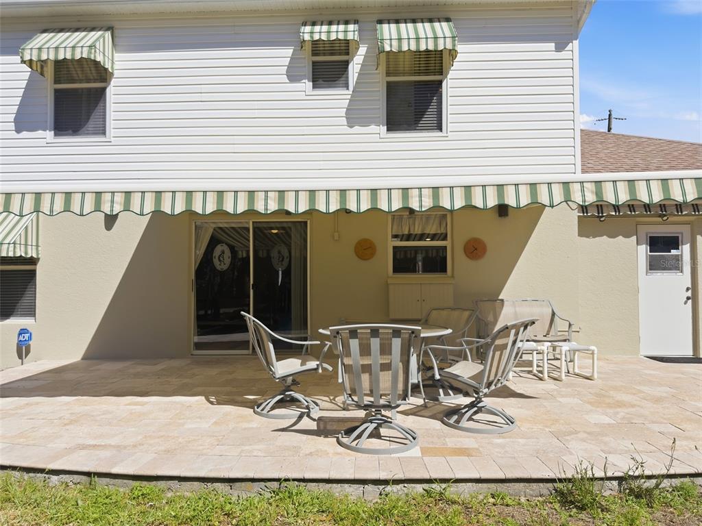 13302 Mitten Lane Spring Hill, FL 34609 - Photo 47 of 59 a view of a patio with table and chairs