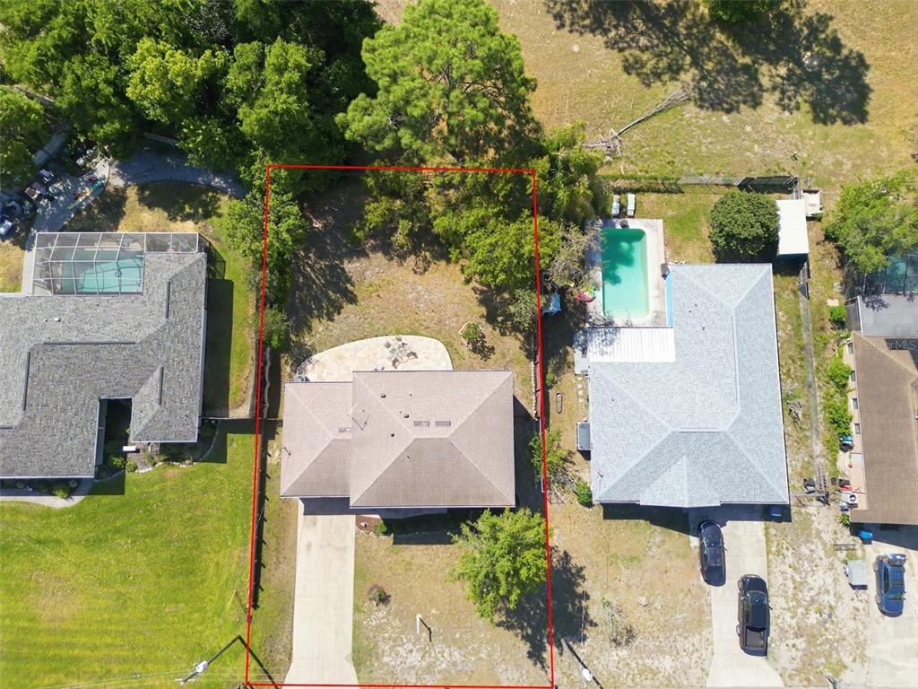 13302 Mitten Lane Spring Hill, FL 34609 - Photo 58 of 59 an aerial view of a house with swimming pool and large trees