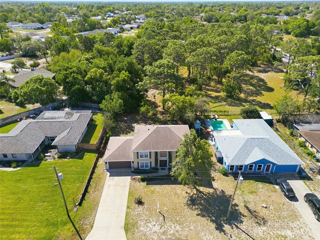 13302 Mitten Lane Spring Hill, FL 34609 - Photo 59 of 59 an aerial view of a house with swimming pool and lake view