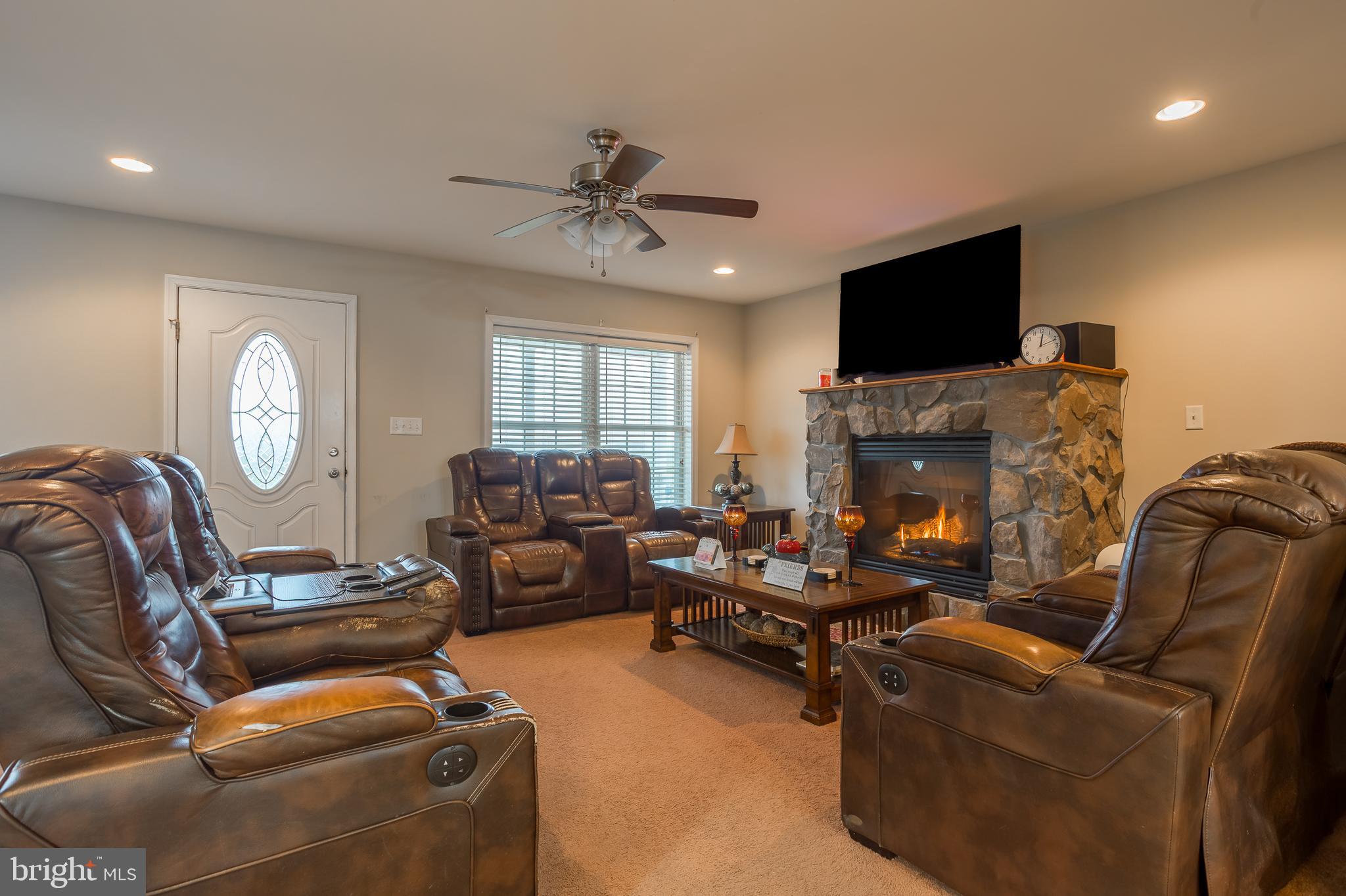 10455 Sunnyside Road Greenwood, DE 19950 - Photo 11 of 46 a living room with furniture fireplace and a flat screen tv