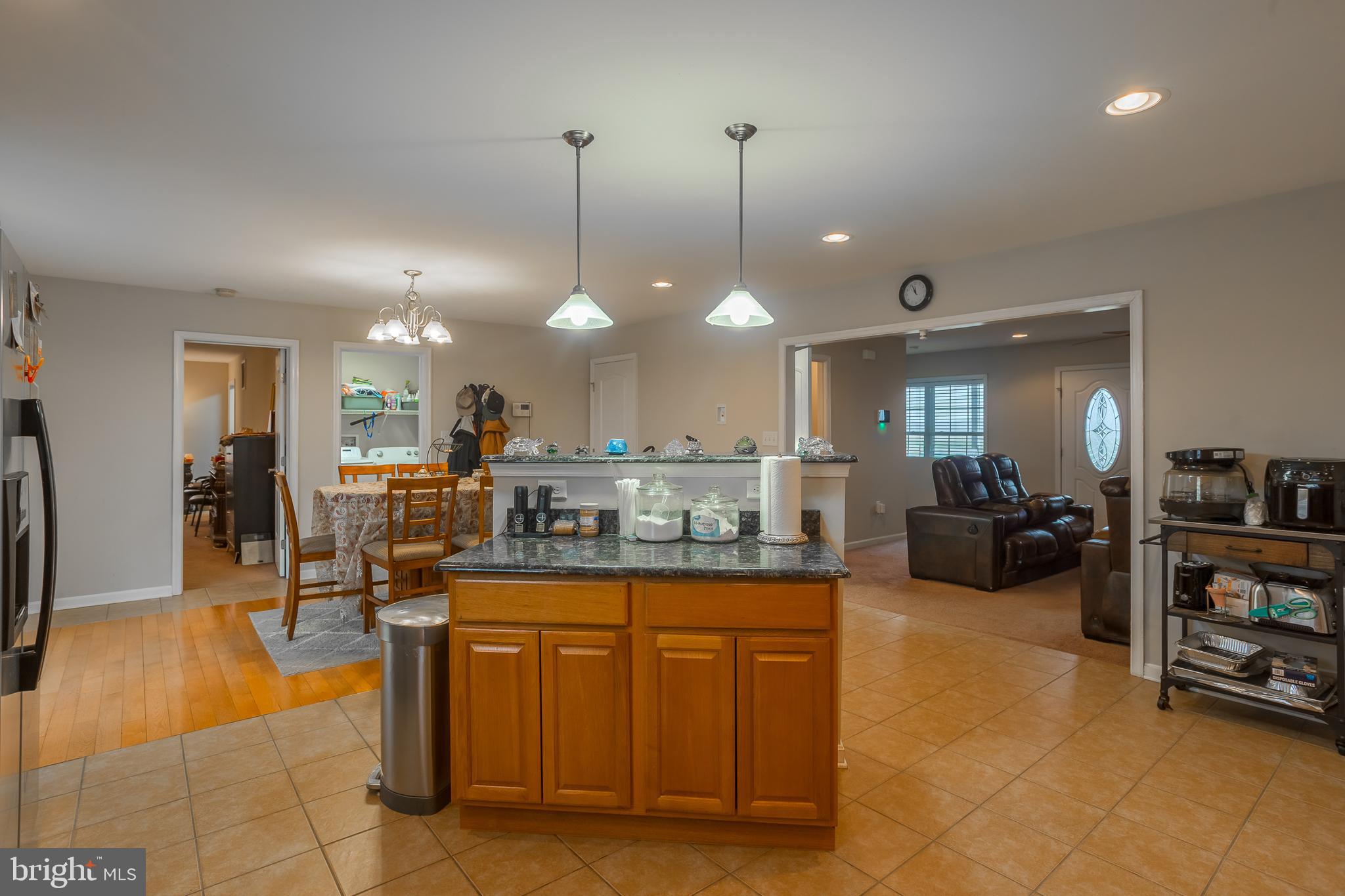 10455 Sunnyside Road Greenwood, DE 19950 - Photo 16 of 46 a dining hall with stainless steel appliances granite countertop a living room view living room and couches with the view of kitchen