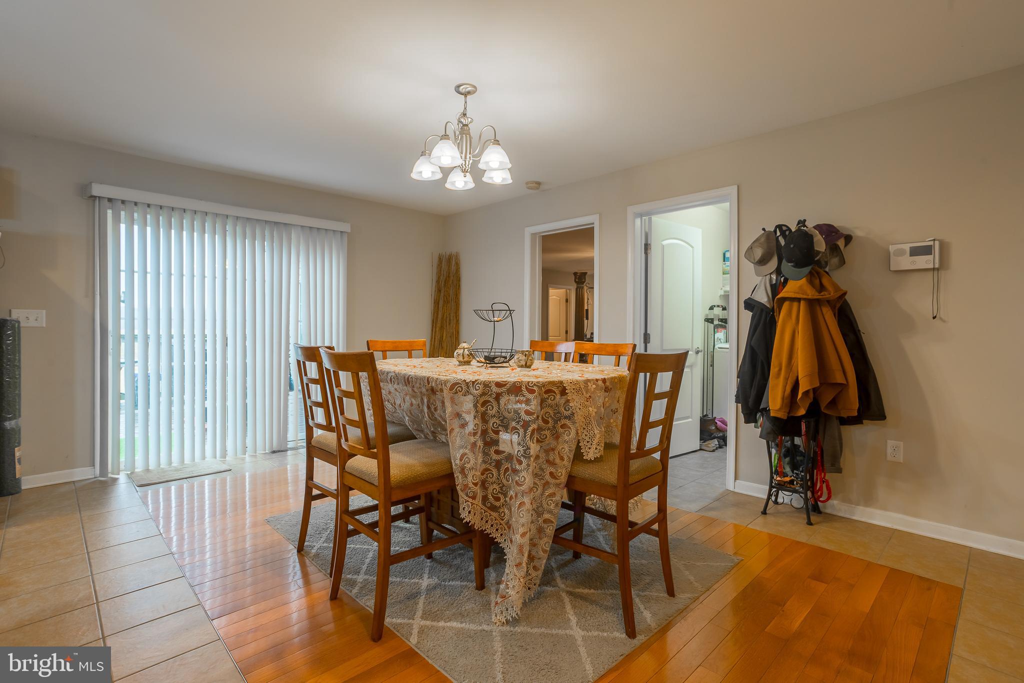 10455 Sunnyside Road Greenwood, DE 19950 - Photo 17 of 46 a view of a dining room with furniture and wooden floor