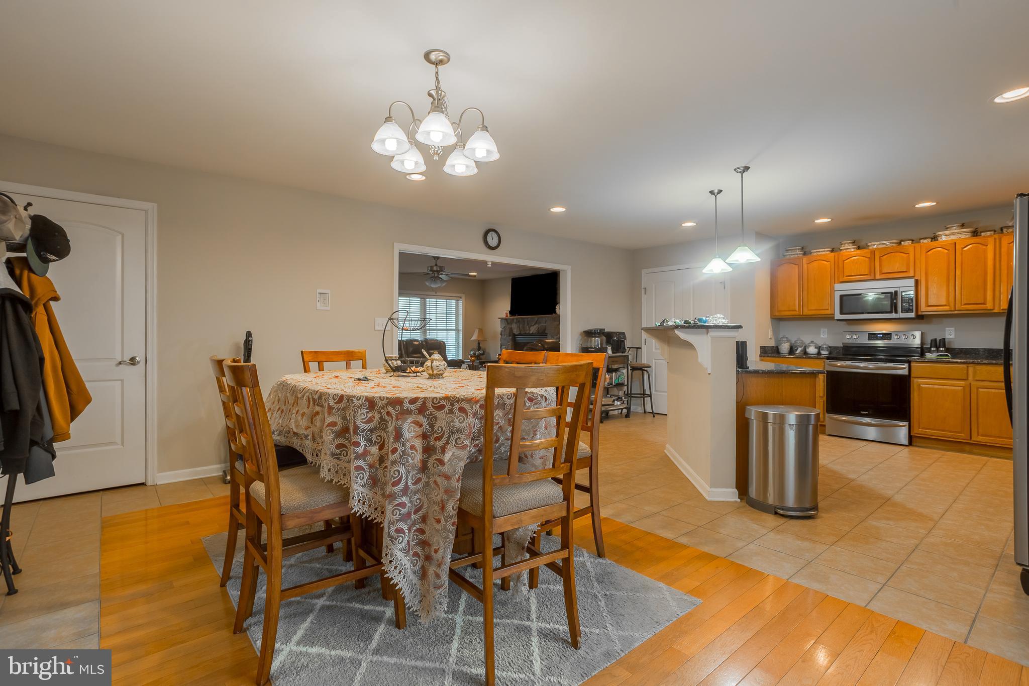 10455 Sunnyside Road Greenwood, DE 19950 - Photo 19 of 46 a view of a dining room with furniture and a chandelier