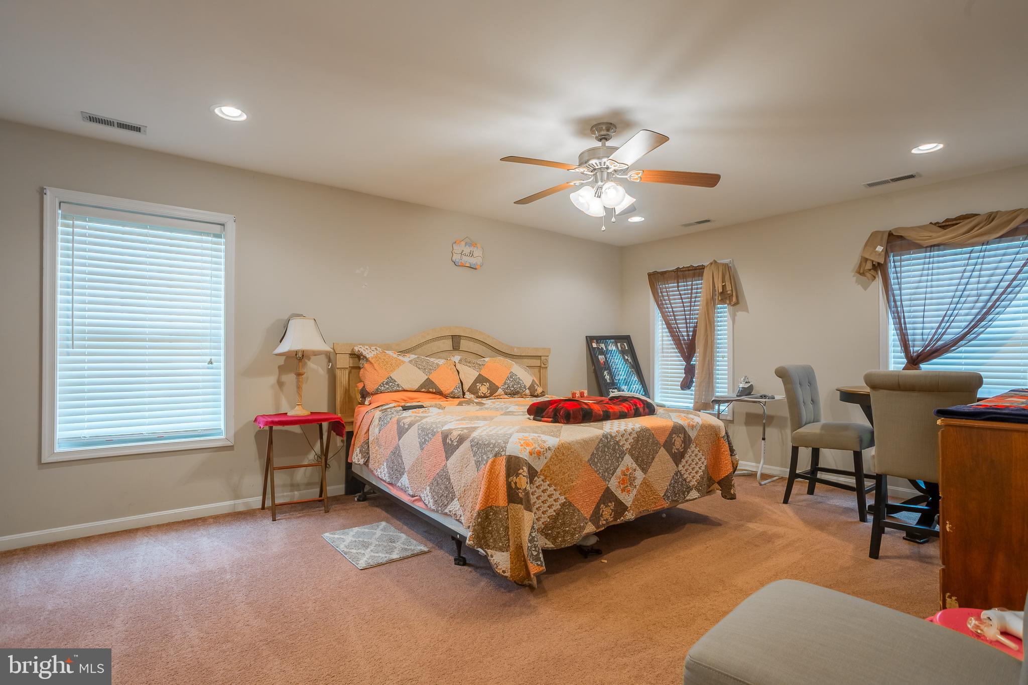 10455 Sunnyside Road Greenwood, DE 19950 - Photo 32 of 46 a bed room with a bed and a chandelier