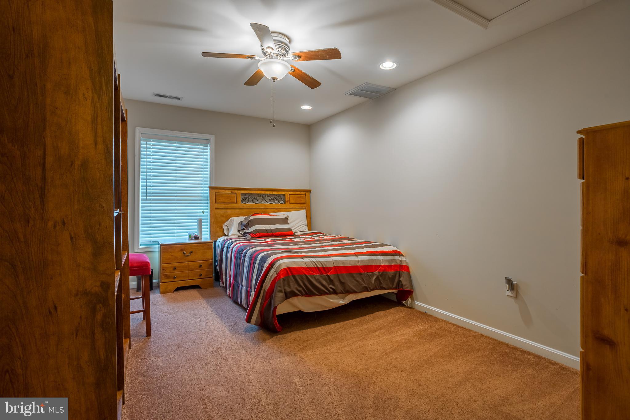 10455 Sunnyside Road Greenwood, DE 19950 - Photo 35 of 46 a bedroom with a bed and a chandelier