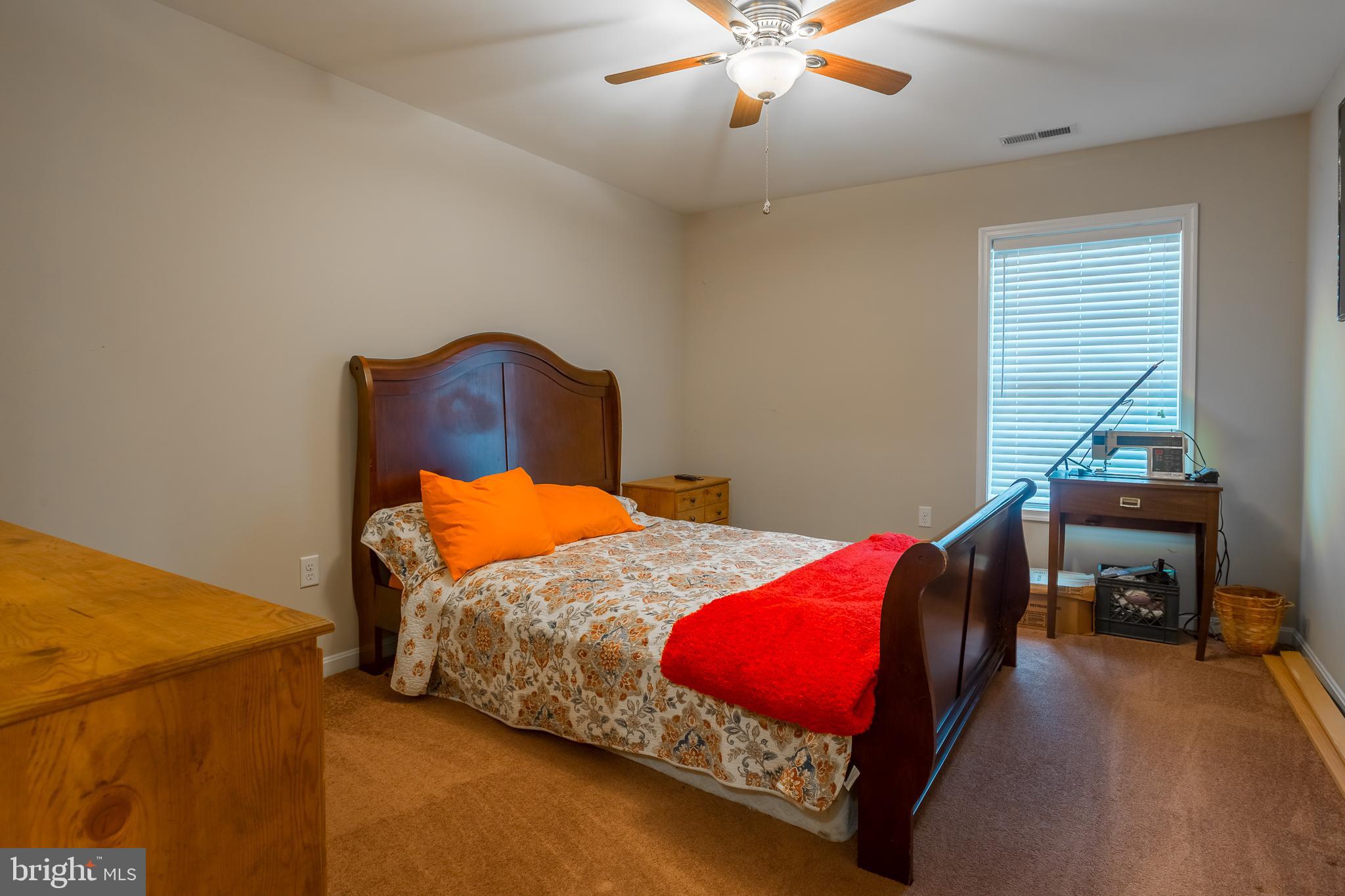 10455 Sunnyside Road Greenwood, DE 19950 - Photo 36 of 46 a bedroom with a bed and a chandelier