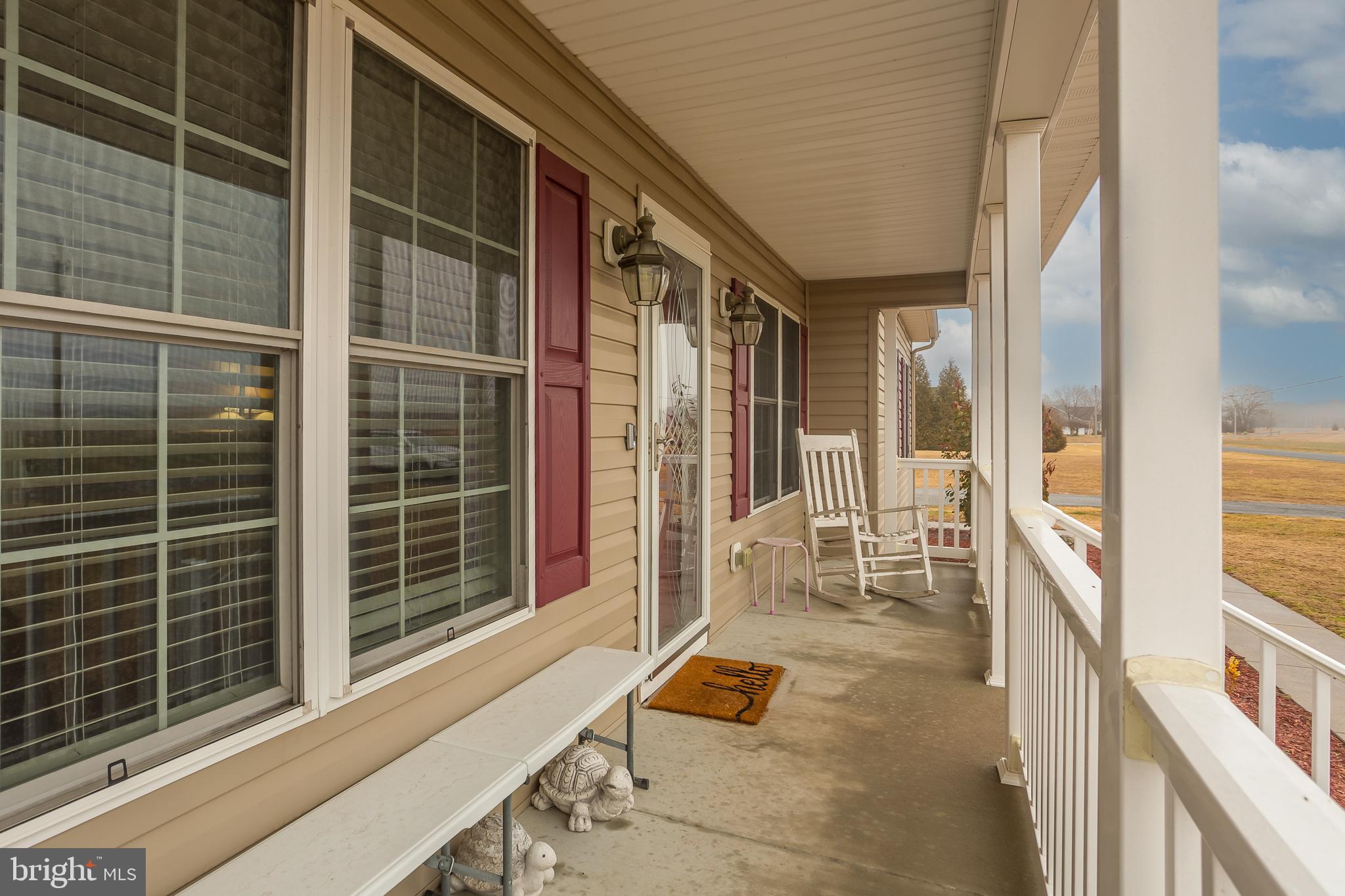 10455 Sunnyside Road Greenwood, DE 19950 - Photo 9 of 46 a balcony with couch and a potted plant on a table