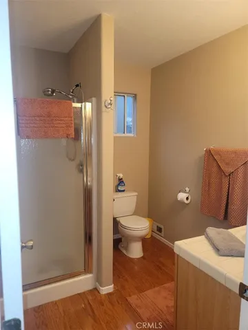 a bathroom with a granite countertop sink toilet and shower