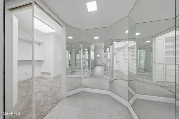 a view of walk in closet with empty racks