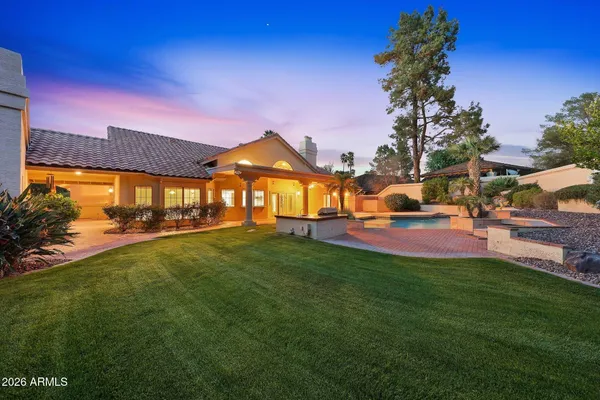 a backyard of a house with table and chairs