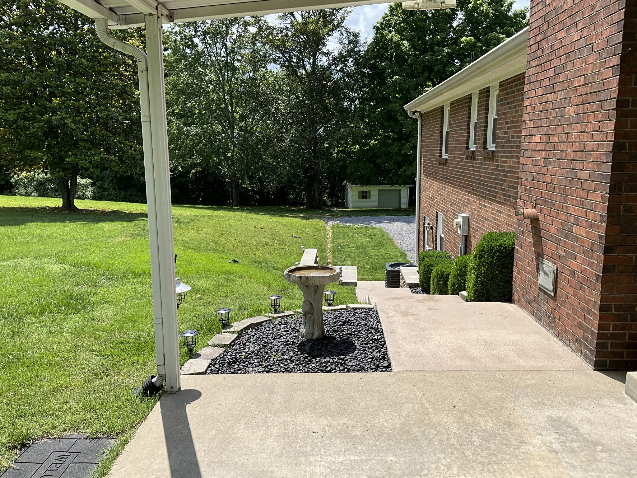 5247 Stacy Springs Road Springfield, TN 37172 - Photo 24 of 29 a view of a backyard with table and chairs potted plants and large tree