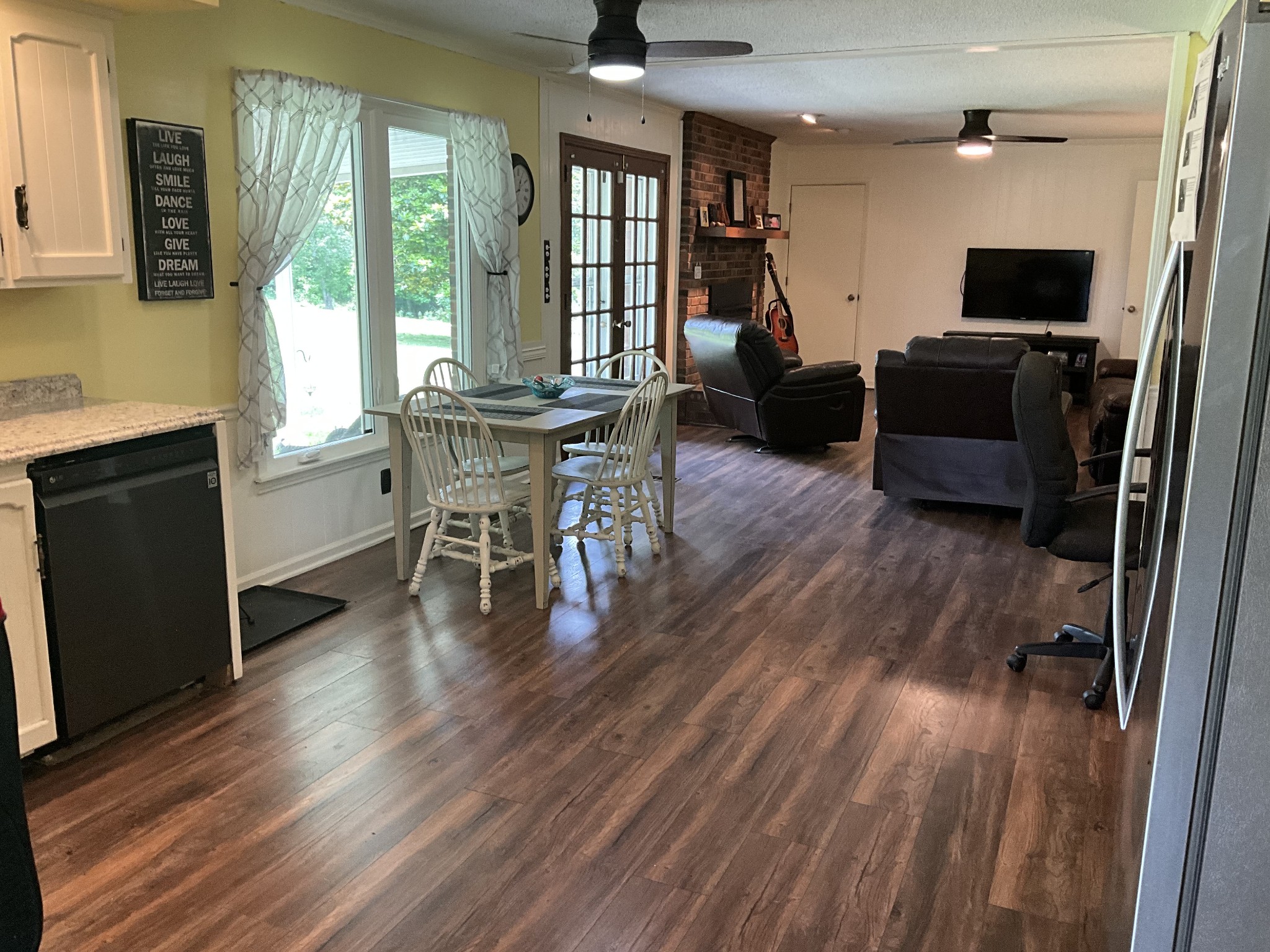 5247 Stacy Springs Road Springfield, TN 37172 - Photo 6 of 29 a dining room with furniture window wooden floor and a fireplace