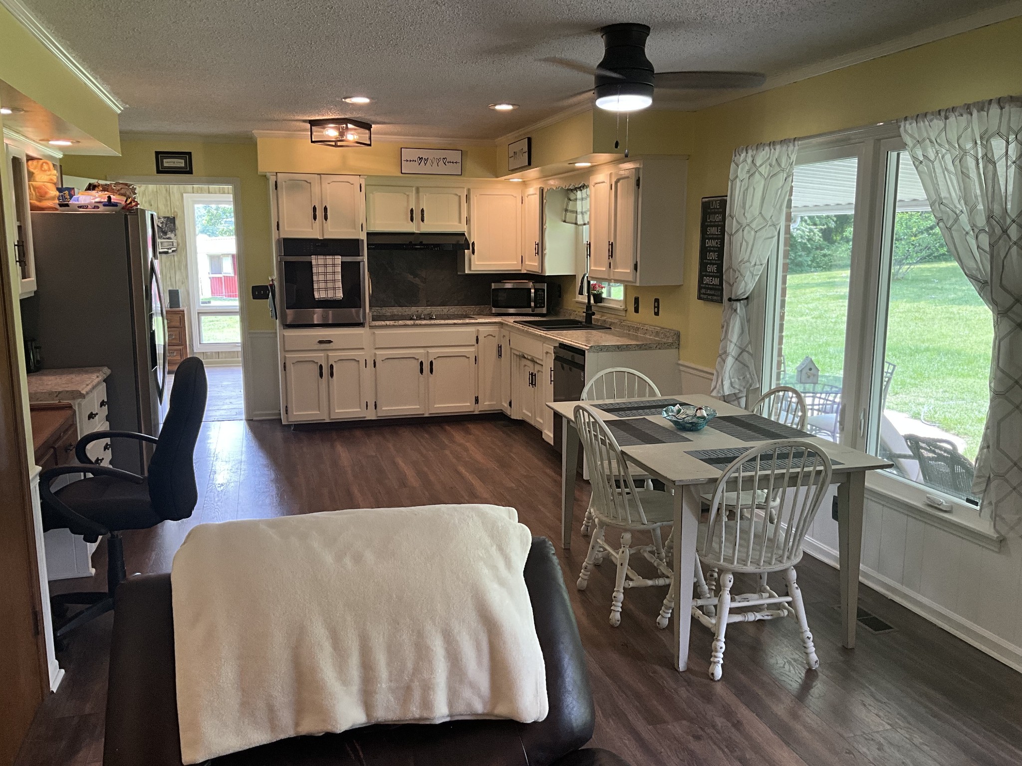 5247 Stacy Springs Road Springfield, TN 37172 - Photo 8 of 29 a kitchen with stainless steel appliances granite countertop a stove a refrigerator a kitchen island a table and chairs
