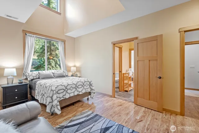 a bedroom with a bed and wooden floor