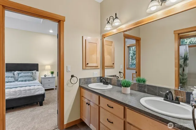 a en suite bathroom with a double vanity sink and a mirror
