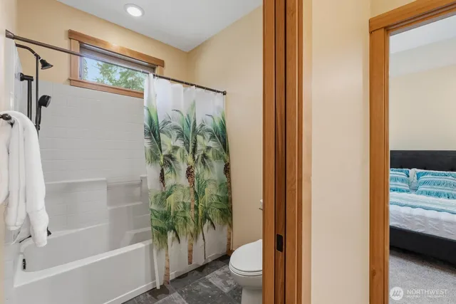 a bathroom with a bathtub and shower