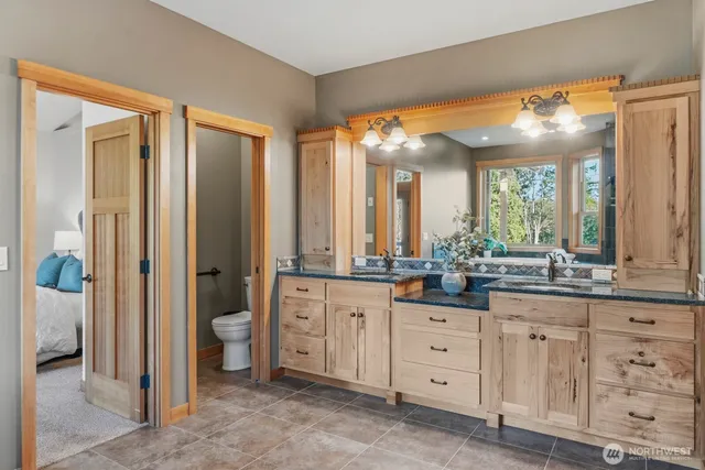 a bathroom with a granite countertop sink mirror and double