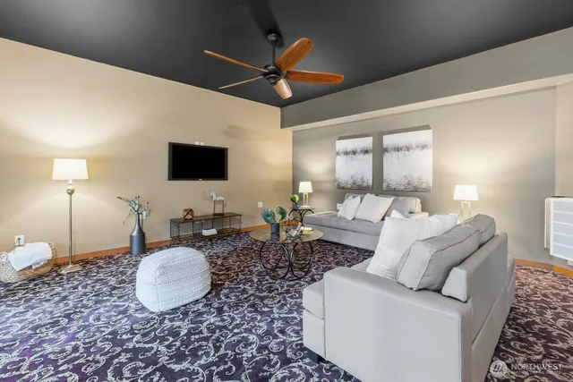 a living room with furniture a chandelier and a flat screen tv