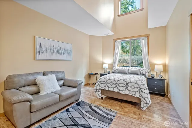 a bedroom with a bed couch and a window