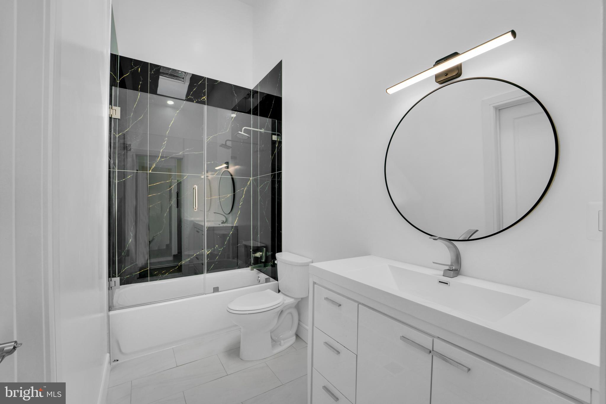 12116 Old Fort Road Fort Washington, MD 20744 - Photo 18 of 65 a bathroom with a sink a toilet and a mirror