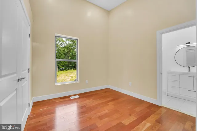 a view of a room with wooden floor and windows