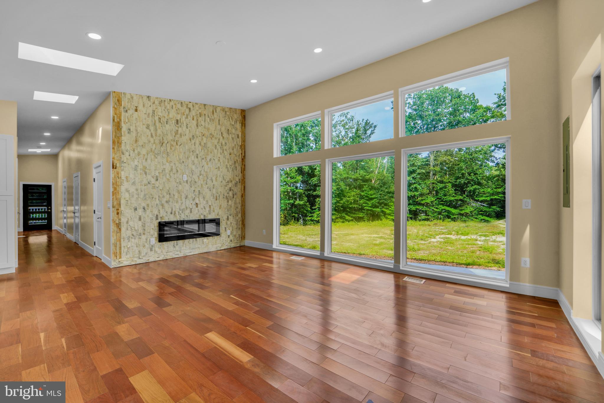12116 Old Fort Road Fort Washington, MD 20744 - Photo 41 of 65 a view of an empty room with a fireplace and a large window