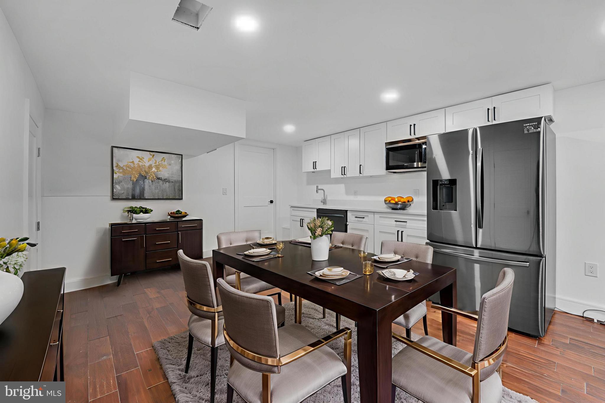 12116 Old Fort Road Fort Washington, MD 20744 - Photo 49 of 65 a kitchen with a refrigerator a stove a dining table and chairs