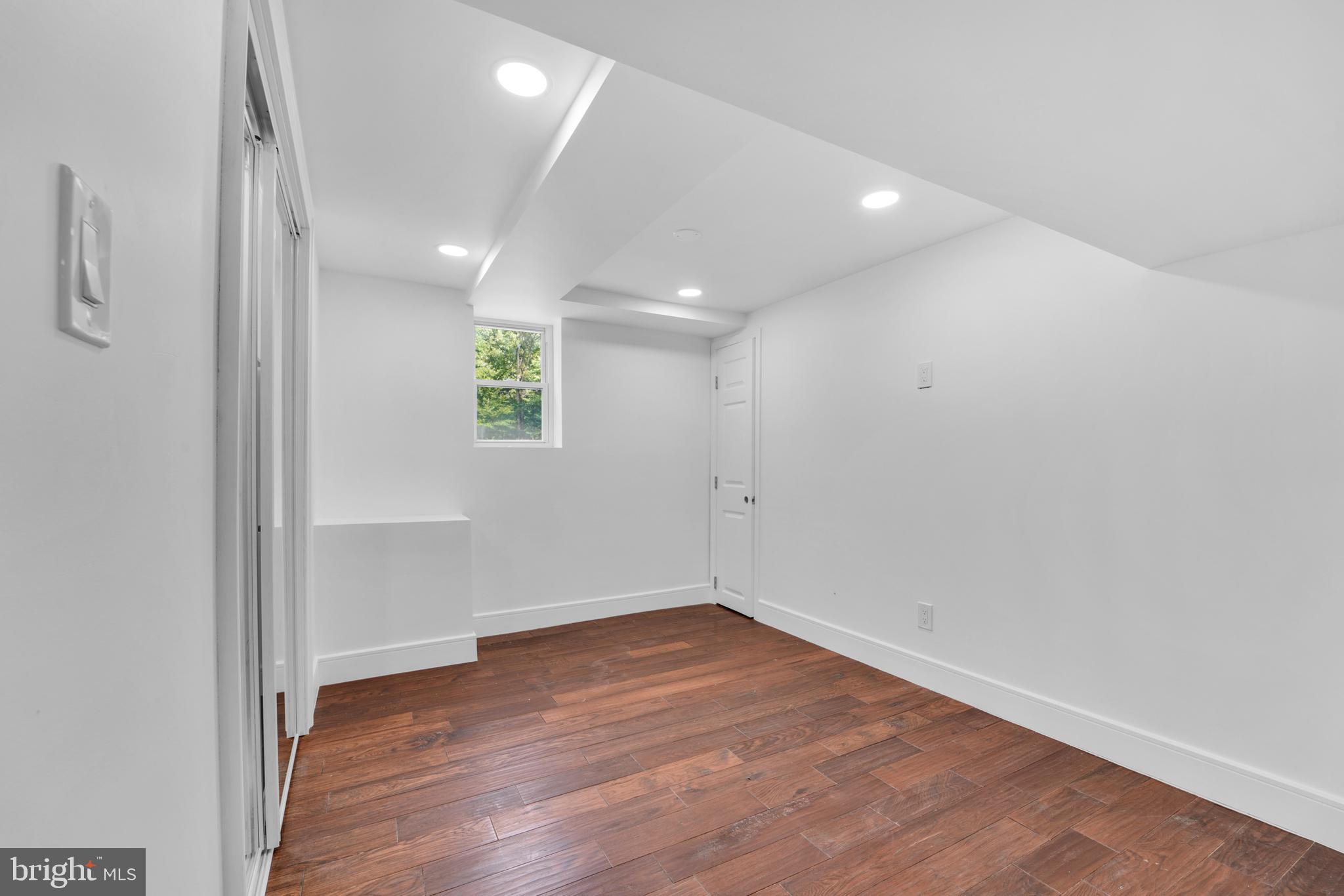 12116 Old Fort Road Fort Washington, MD 20744 - Photo 54 of 65 an empty room with wooden floor and windows