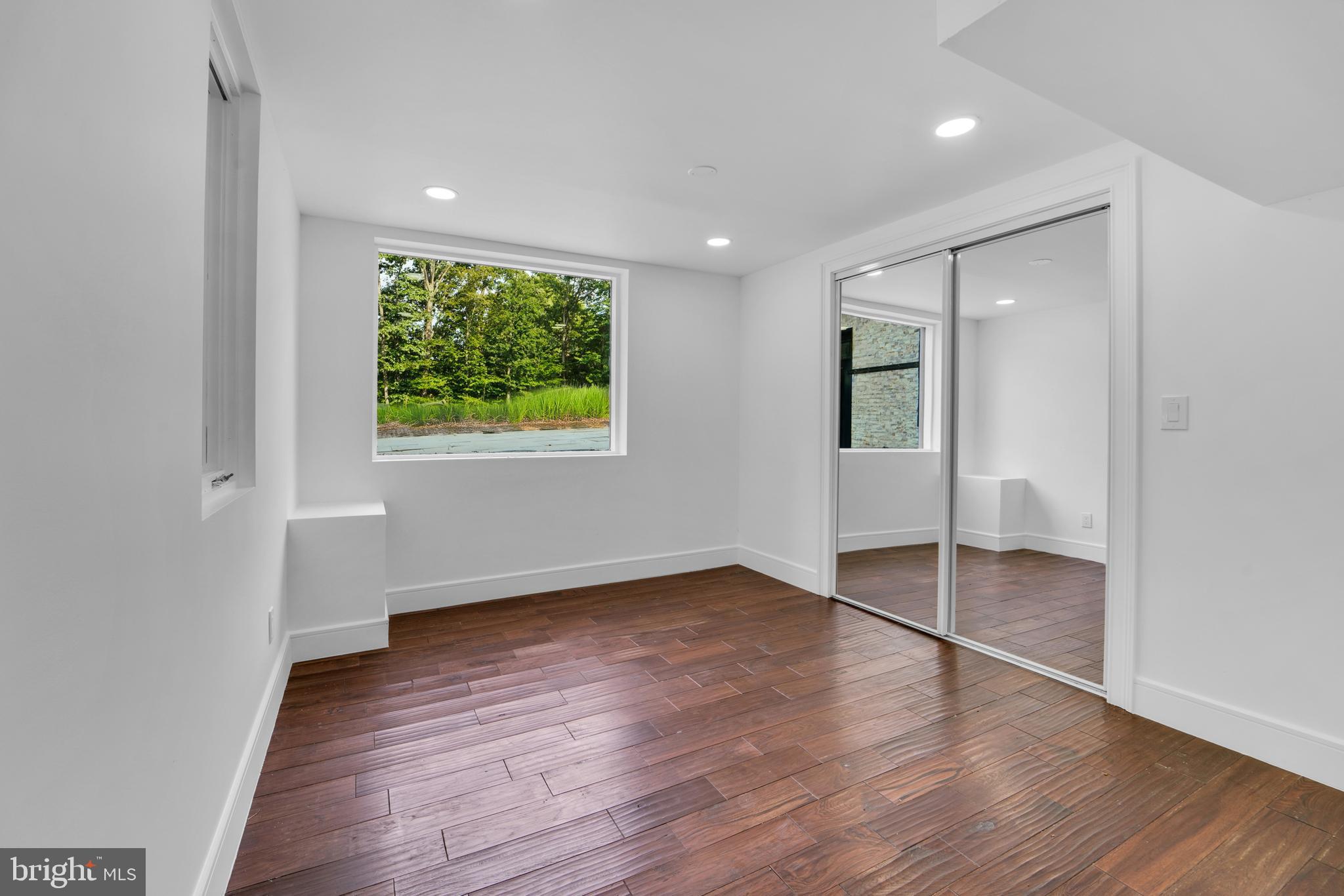 12116 Old Fort Road Fort Washington, MD 20744 - Photo 57 of 65 an empty room with wooden floor and windows