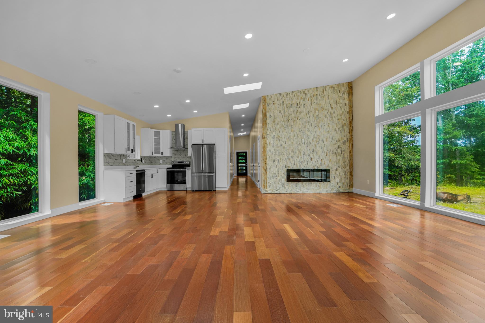 12116 Old Fort Road Fort Washington, MD 20744 - Photo 8 of 65 a view of empty room with wooden floor and fireplace
