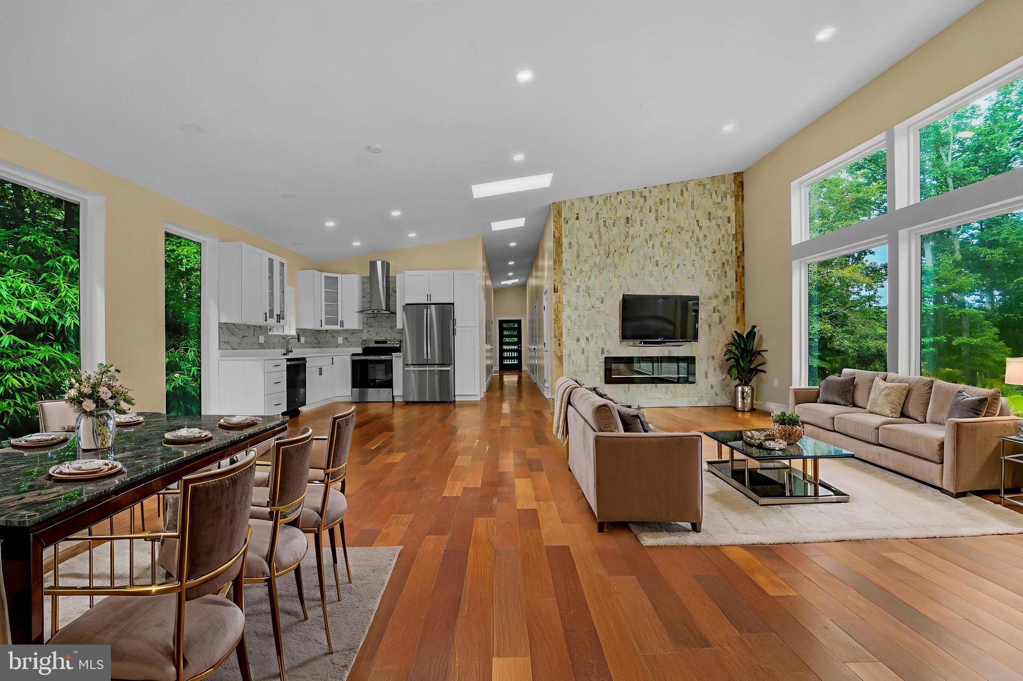 12116 Old Fort Road Fort Washington, MD 20744 - Photo 9 of 65 a living room with furniture a flat screen tv and a floor to ceiling window