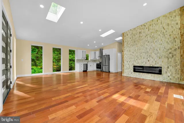 a kitchen with a refrigerator and a stove top oven