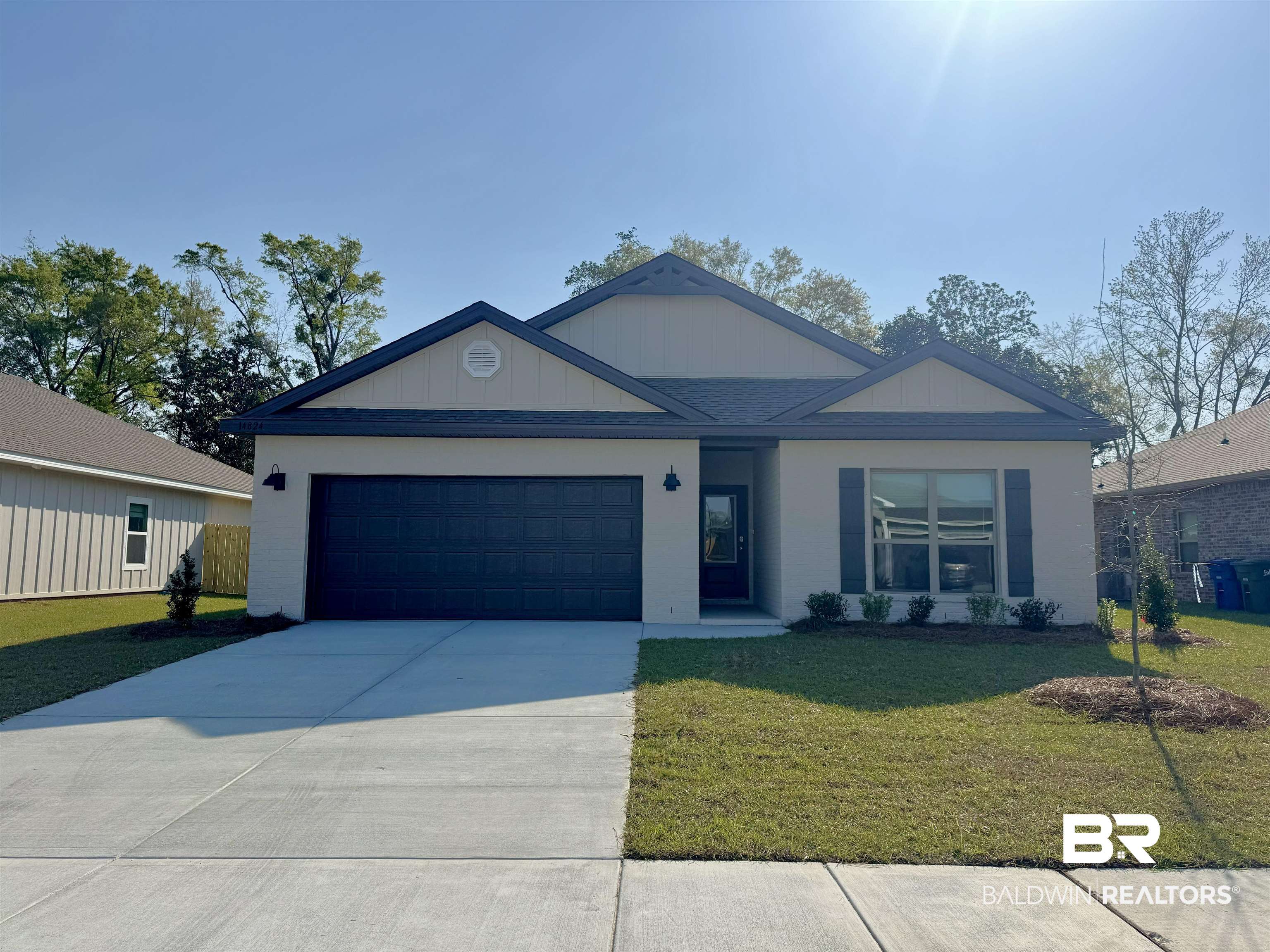 14824 Dayton Circle Foley, AL 36535 - Photo 1 of 36 Ranch-style house featuring a front lawn, concrete driveway, and an attached garage