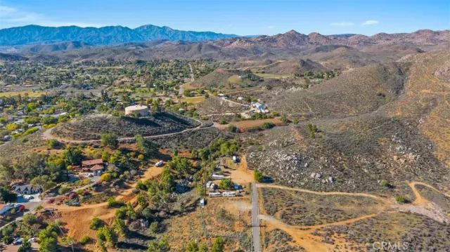 an aerial view of residential house and sandy dunes